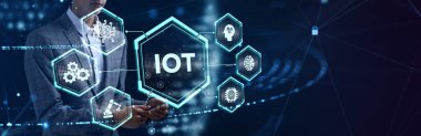 Nesnelerin interneti - IOT konsepti. İşadamı IOT ürünleri ve çözümler sunuyor. Genç işadamı sanal ekranda IoT metin ile soyut çipi seçin.     