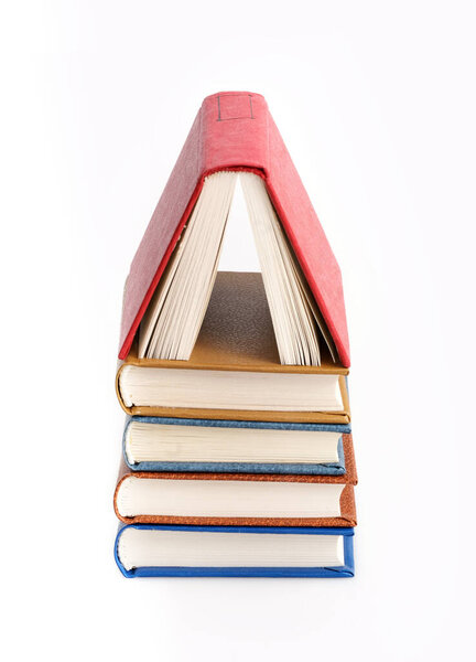 Stack of red, blue, yellow and brown books isolated on a white background