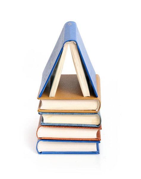 Stack of books in colour covers with white sheets isolated on a white background