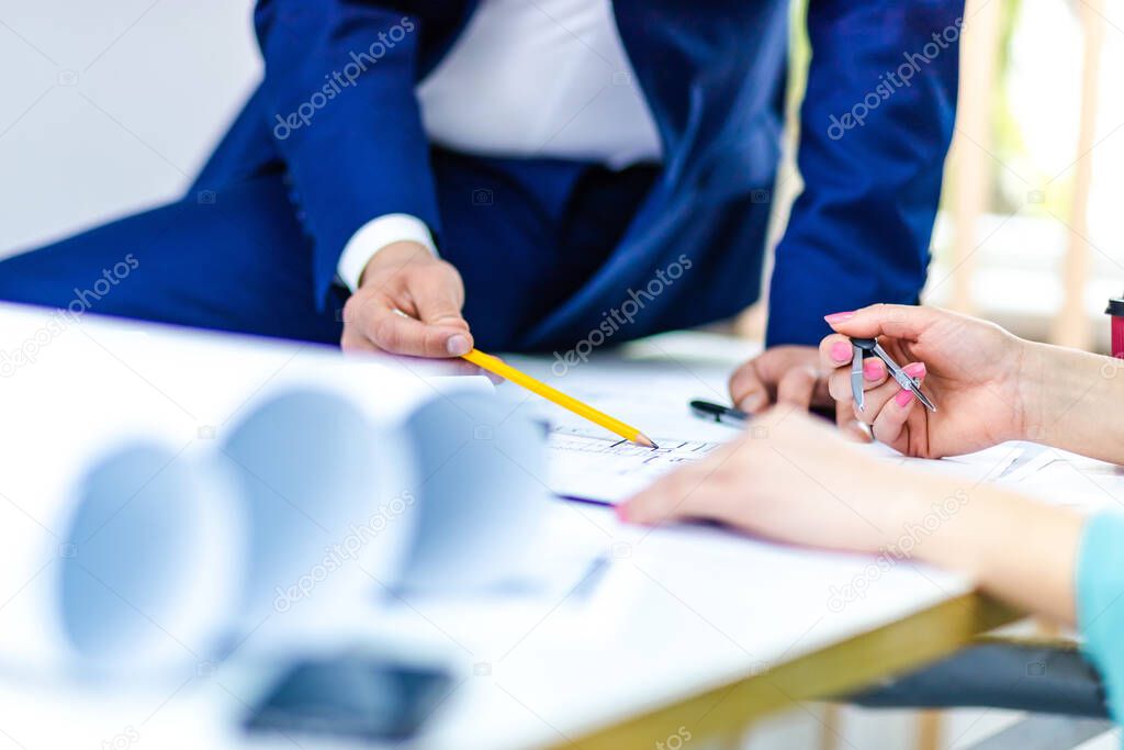 Close up photo of hands working with papers at office.