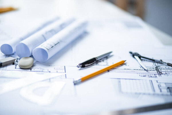 Photo of architectural project, blueprints and engineering tools.