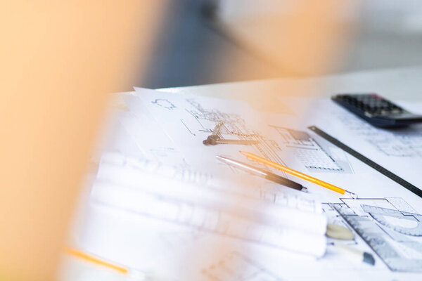 Photo of architectural project, blueprints and engineering tools.