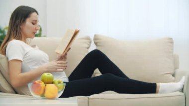Hamile bir kadının kitap okuyup elma yediği 4K video..