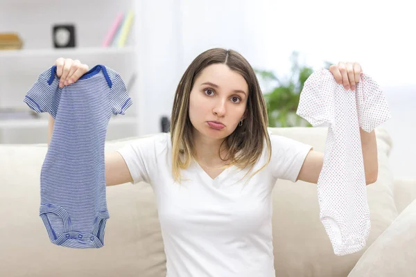 Photo of pregnant woman holding child small clothes. — Stock Photo, Image