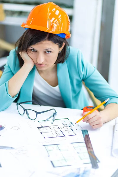 Photo of female worker with work papers at the office. Concept of office occupation.