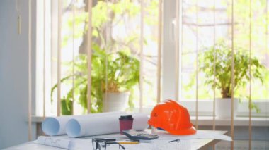 4k slow motion video of man in blue suit near the table with tools. Concept of office.