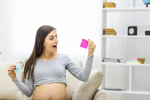 将来の赤ちゃんのセックスを意味するピンクと青の紙を持っている肯定的な妊婦の写真 妊婦の概念 — ストック写真