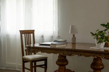 Ev tasarımı, oturma odası çalışma alanı antika masa, kişisel bilgisayar ve kitaplar.