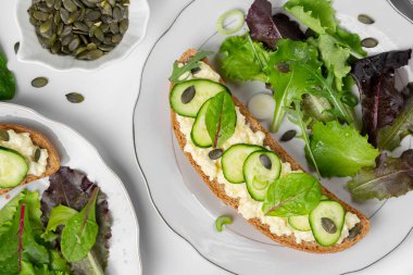 Sağlıklı yiyecekler. Keçi peynirli ve yeşillikli sandviçler, yemeye hazır.