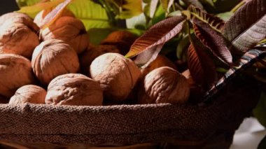 Whole walnuts in basket, food harvest, rustic style