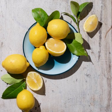Raw fresh lemons on light wooden background. Harvest, agricultural concept, healthy organic ingredients