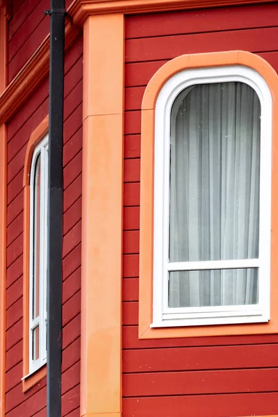 Part of red-orange colorful building, exterior detail
