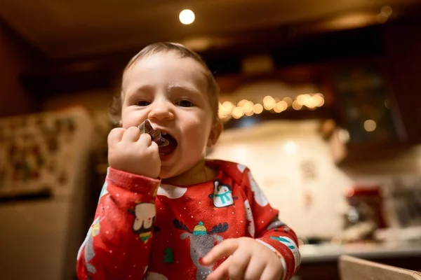 Baby boy in pajamas in Christmas kitchen — Stock Photo, Image