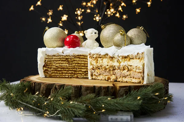 A slice of a cake on a background of christmas lights. — стоковое фото