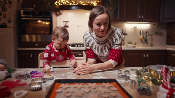 Leuke kinderen maken koekjes met moeder op kerstdag thuis — Stockvideo
