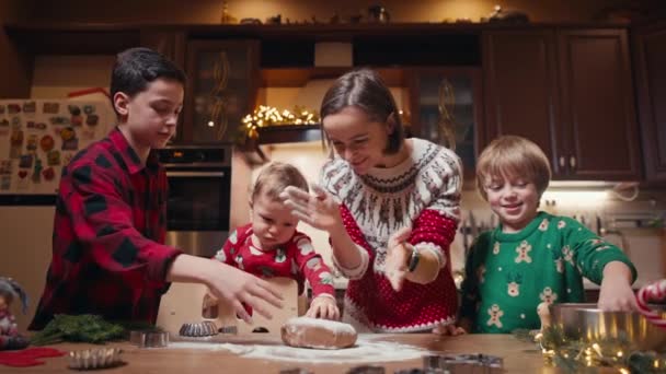 Family with three kids cooking ginger cookies. Merry Christmas, Happy New Year. Family time, preparation for holidays. — Wideo stockowe