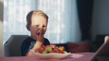 Mutlu çocuk sütle çilek yiyor.