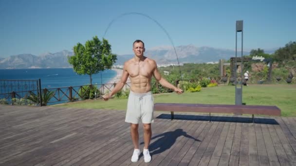Slow Motion Shot Man Having Cardio Training Outdoors Throwing Skipping — Stockvideo
