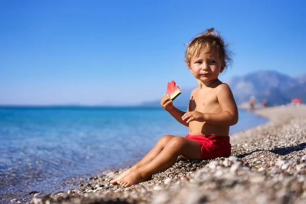 Молодий Малюк Їсть Смачну Пару Ватермелон Березі Океану Прекрасному Пляжі Стокова Картинка