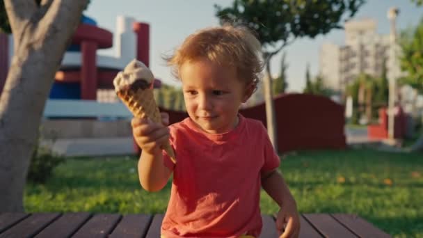 Fair Haired Boy Eats White Cold Cream Ice Cream Waffle — Stockvideo