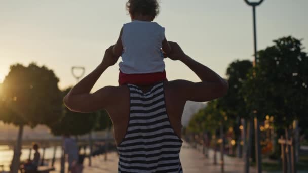 Father Son Walking City Sunset Two Year Old Kid Sitting — Vídeo de stock