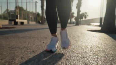 front view of athletic woman running on seaside at summer. High quality 4k footage