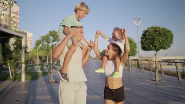 Happy Parents Little Cute Sons Fathers Mothers Neck Walking Promenade — 图库视频影像