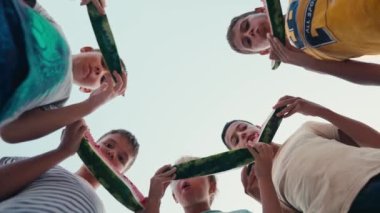 Four school children eating watermelon outdoor at summer time, happy summer concept. High quality 4k footage