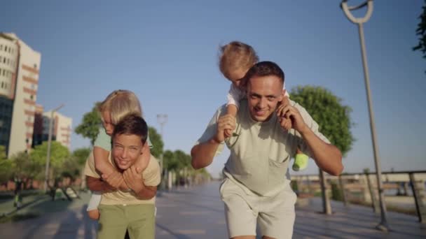 Father Play Little Children Outdoor Happy Smiling Father Hold Back — Stockvideo
