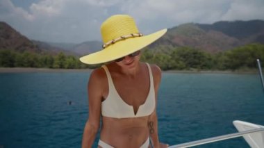 Bikini beach woman happy smiling playful cheerful having fun dancing around. Bikini girl wearing sunglasses excited and joyful. Beautiful caucasian race woman having fun on summer travel vacation