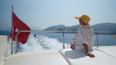 While resting on a yacht, the mother sit with her baby at dusk, family relationships. High quality 4k footage
