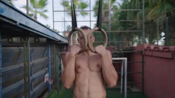 Strong Man Performing Pull Ups Gymnastic Rings Slow Motion High — Stockvideo