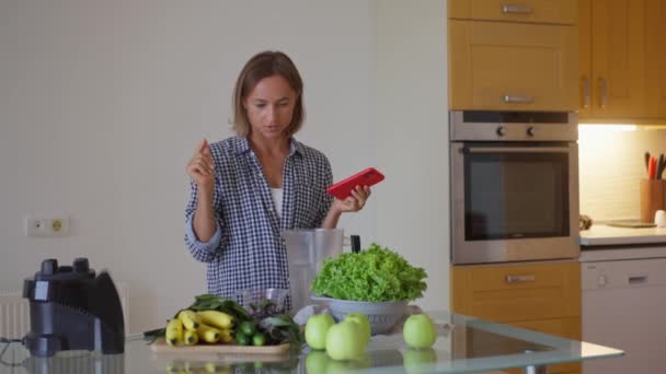 Young Sportswoman Putting Washed Greenery Table Cooking Smoothie Happy Vegetarian — 图库视频影像