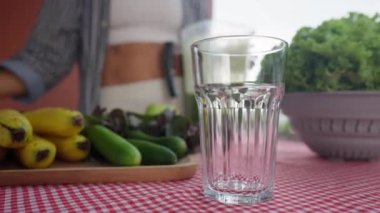 Young smiling woman drinking detox smoothie through straw. Happy vegetarian drinks fresh green vegetable cocktail. Weight Loss, slimming Concept. Healthy eating habits. High quality 4k footage