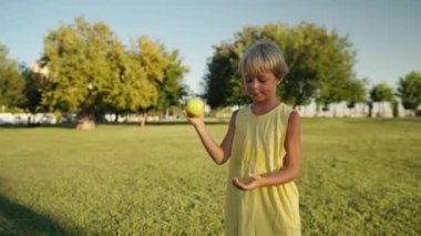 Child throwing up an apple. Healthy Life Healthy Food.
