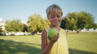 Child throwing up an apple. Healthy Life Healthy Food.