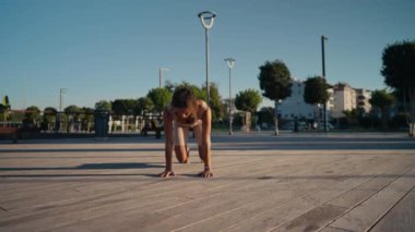 Young woman doing exercise outdoor animal flow innovative movement. Young caucasian woman doing workout at sunrise