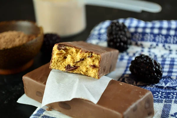 close-up shot of delicious protein bars with chocolate and blackberries