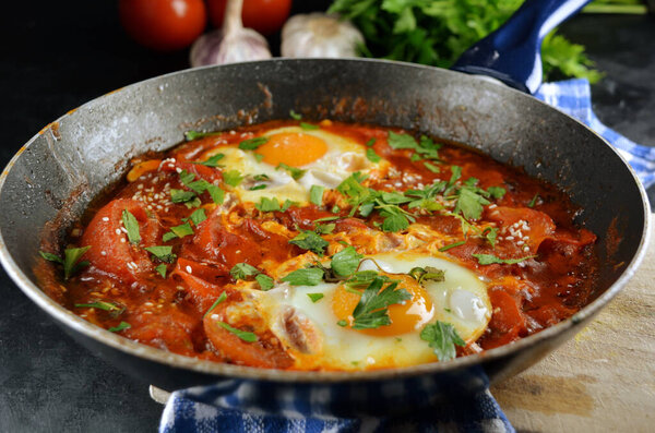 close-up shot of delicious fried eggs with tomatoes