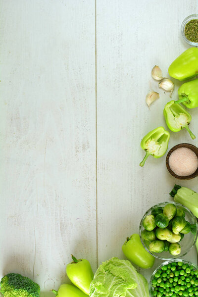 Fresh Green Vegetables on White Wooden Background 