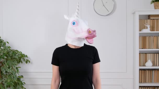 Woman in unicorn head showing sporty strong arms - funny weird video — Stock Video