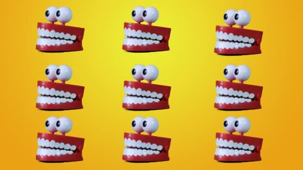 Funny Toy Teeth Jaw collage, Contemporary Art. Multiple chattering teeth toy moving on yellow background. — Stock Video