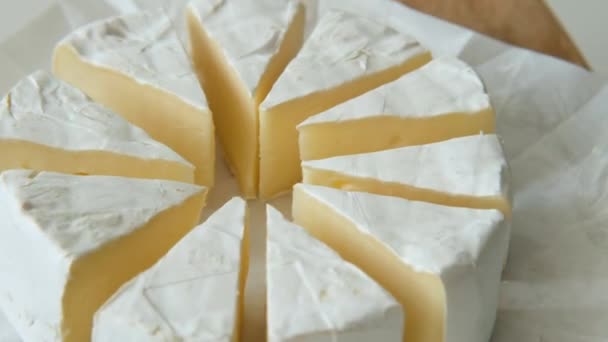 Sliced sectors of soft cheese brie or camambert rotating, close up — Stock Video