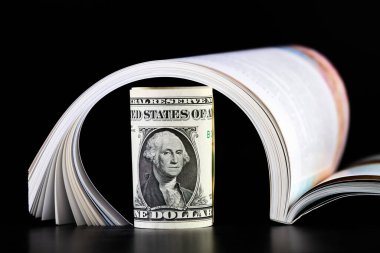 Bir dolarlık banknotu açık bir derginin yanına yuvarladım.