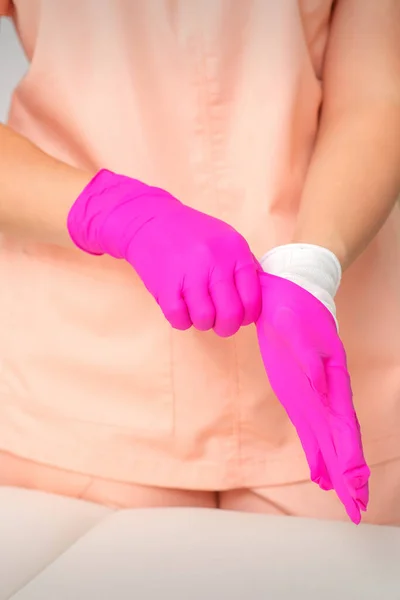 Hand Beautician Puts Sterile Pink Gloves Prepares Receive Clients Indoors — Stock Photo, Image