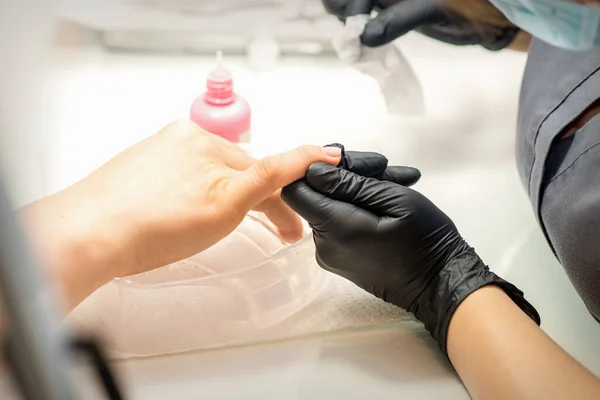 Close Professional Manicure Master Holds Female Hand Customer Disinfects Nails — 스톡 사진