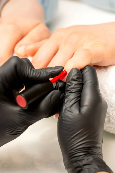 Manicure Varnish Painting Close Manicure Master Wearing Rubber Black Gloves — стоковое фото