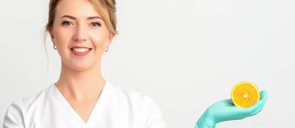 Smiling Female Nutritionist Holding Sliced Orange Looking Camera White Background — Fotografia de Stock