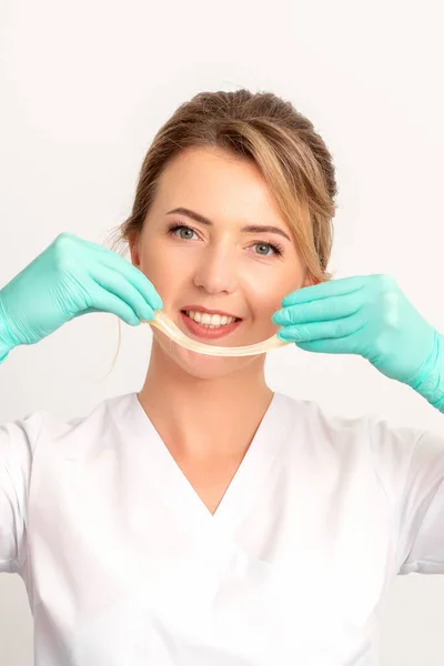 Young Caucasian Smiling Female Beautician Holding Wax Depilation White Background — Stock Photo, Image