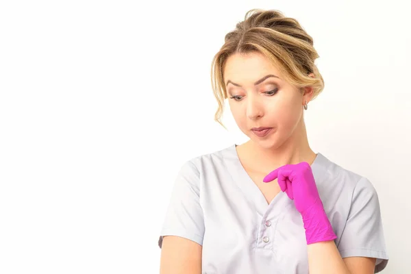 Young Caucasian Female Doctor Wearing Gloves Thoughtful Looking White Background — Stock fotografie